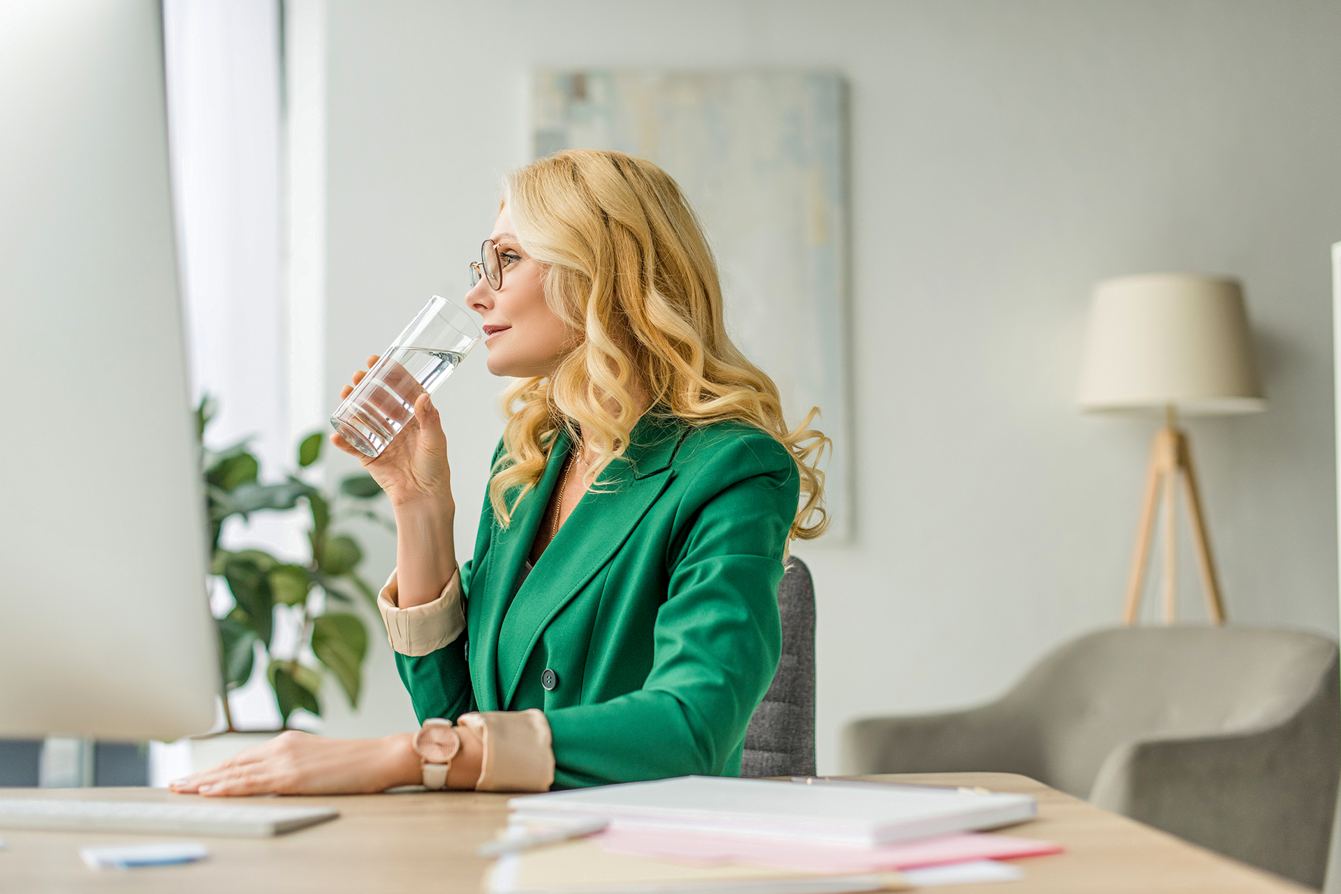 Woman-Drinking-Water-At-Desk